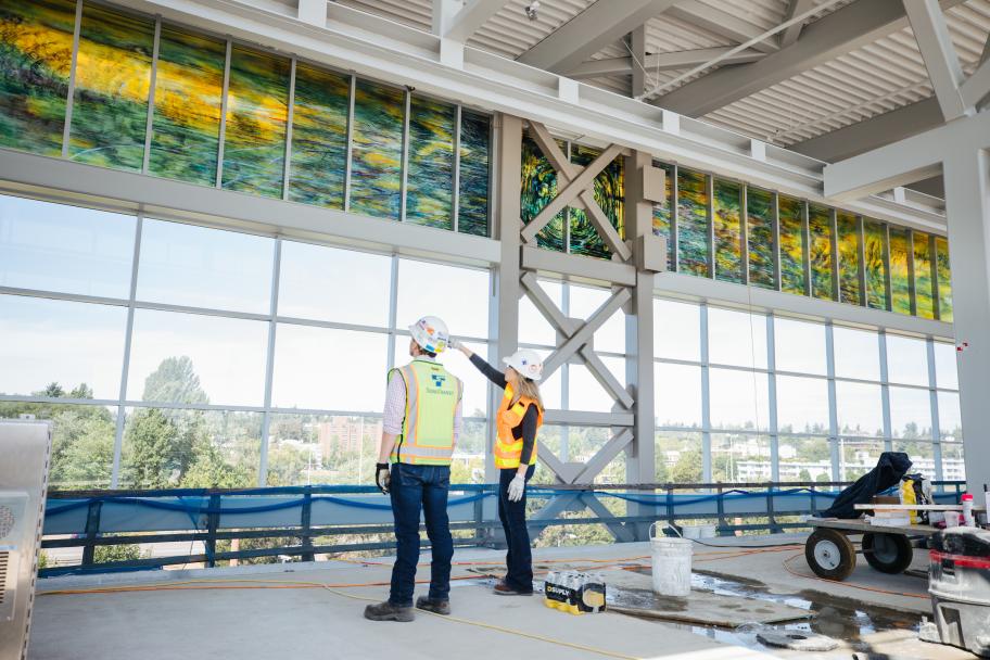 Photo of station art at Northgate Station, depicting a green darner dragonfly on a panel of glass.